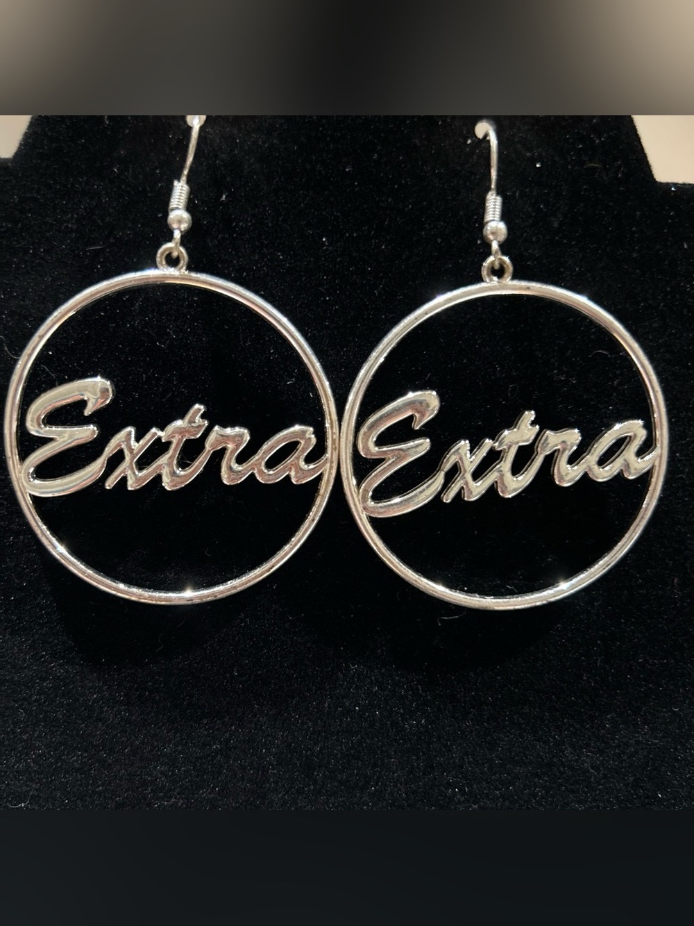Silver color dangle earrings with words extra